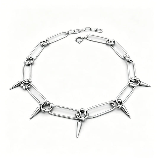 Stainless steel spike link chain choker necklace with polished silver finish and hanging spike accents.