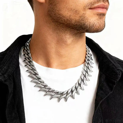 Model wearing a stainless steel fang link chain necklace with a bold gothic streetwear aesthetic.