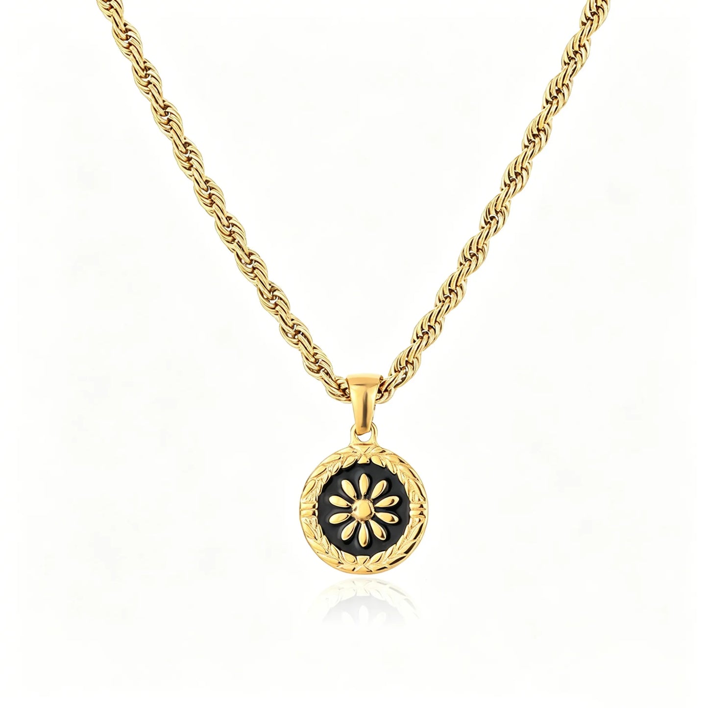 Gold-tone floral medallion pendant necklace with black enamel round charm