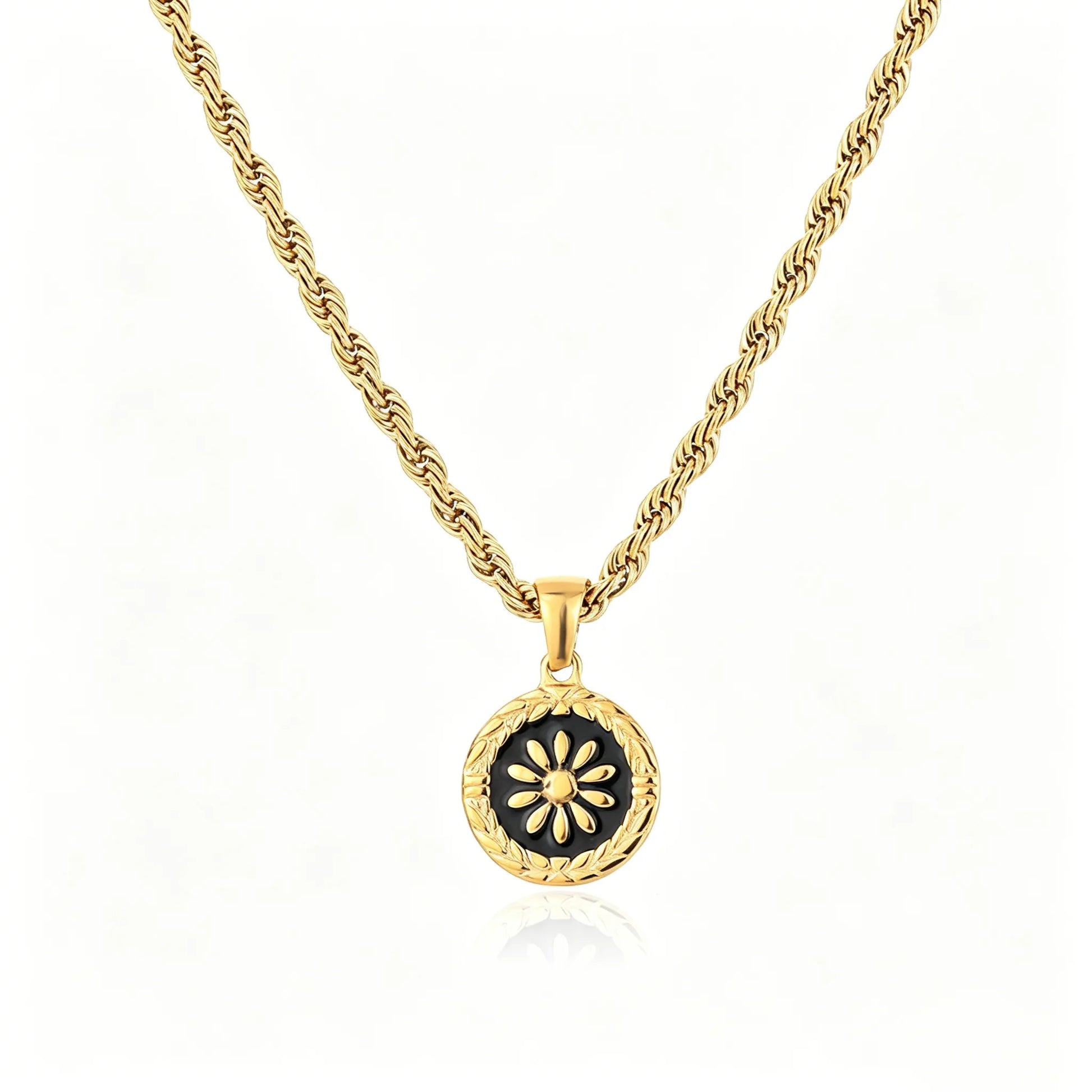 Gold-tone floral medallion pendant necklace with black enamel round charm