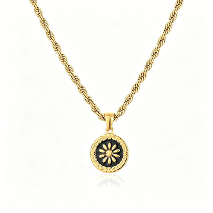 Gold-tone floral medallion pendant necklace with black enamel round charm