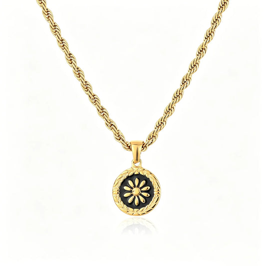 Gold-tone floral medallion pendant necklace with black enamel round charm