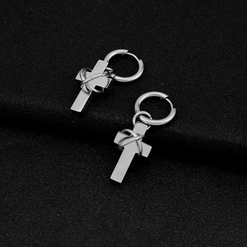 Barbed cross hoop earrings in polished stainless steel with dangling cross pendants.