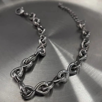 Infinity link stainless steel bracelet with polished silver finish and adjustable lobster clasp.