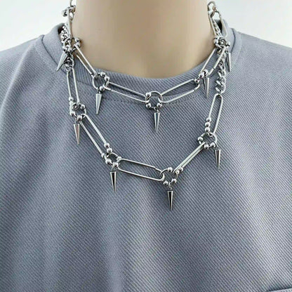 Silver-tone stainless steel punk choker necklace featuring elongated links and cone spike details.