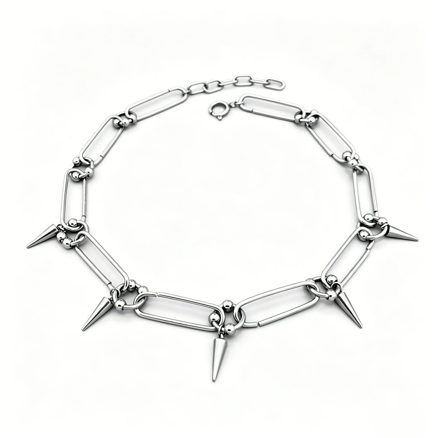 Stainless steel spike link chain choker necklace with polished silver finish and hanging spike accents.