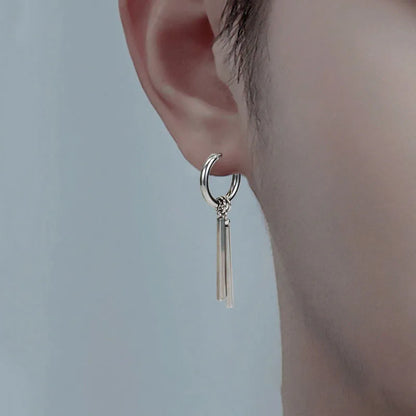 Close-up of a model wearing an edgy stainless steel bar dangle hoop earring.