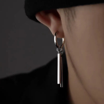 Close-up of a model wearing an edgy stainless steel bar dangle hoop earring.